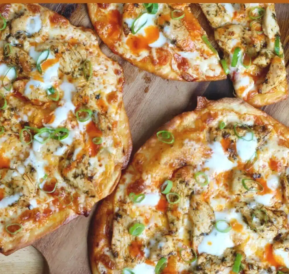 Buffalo Chicken Flatbread topped with fresh ingredients and spicy sauce