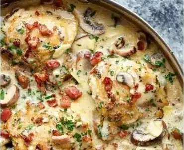 Creamy garlic mushroom chicken topped with bacon and fresh herbs