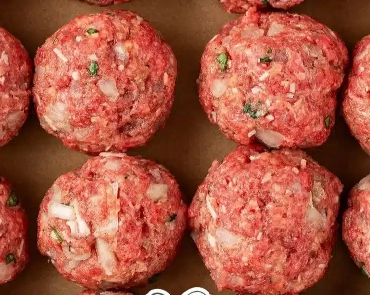 Plate of homemade meatballs served with marinara sauce and spaghetti