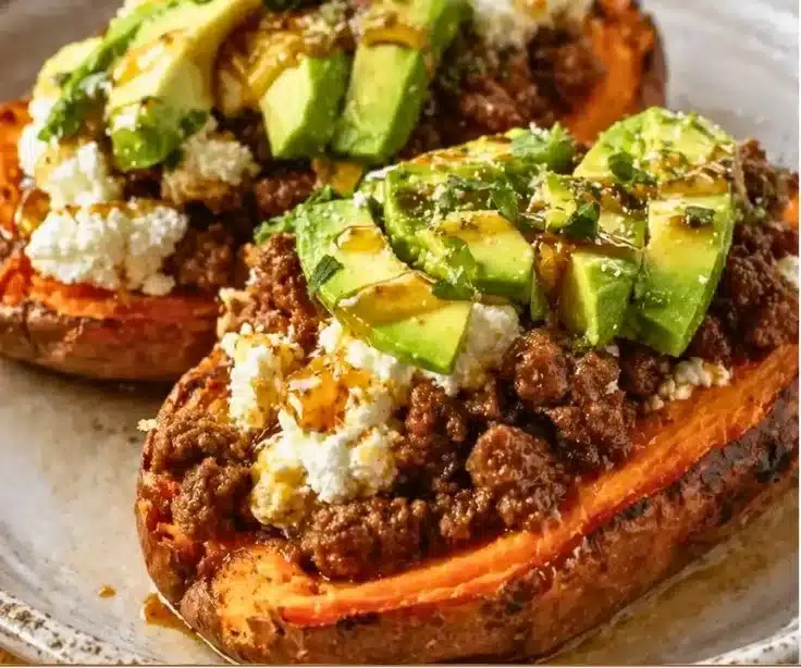 Hot Honey Beef Sweet Potato Boats topped with cottage cheese and garnished.