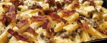 Creamy loaded bacon cheeseburger pasta in a bowl with toppings.