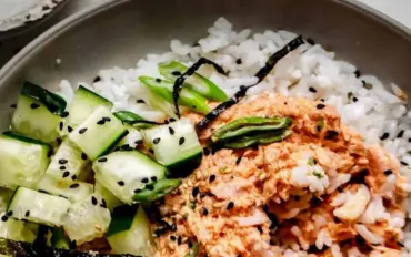 Bowl of spicy tuna rice topped with avocado and sesame seeds