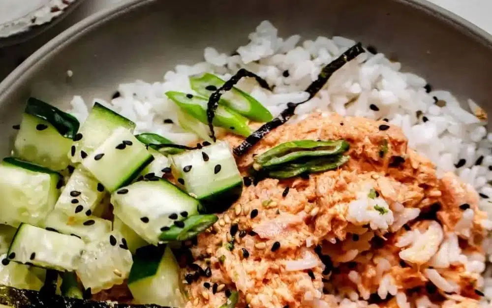 Bowl of spicy tuna rice topped with avocado and sesame seeds